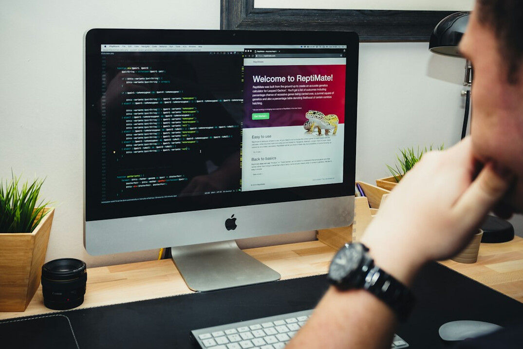 person coding on laptop