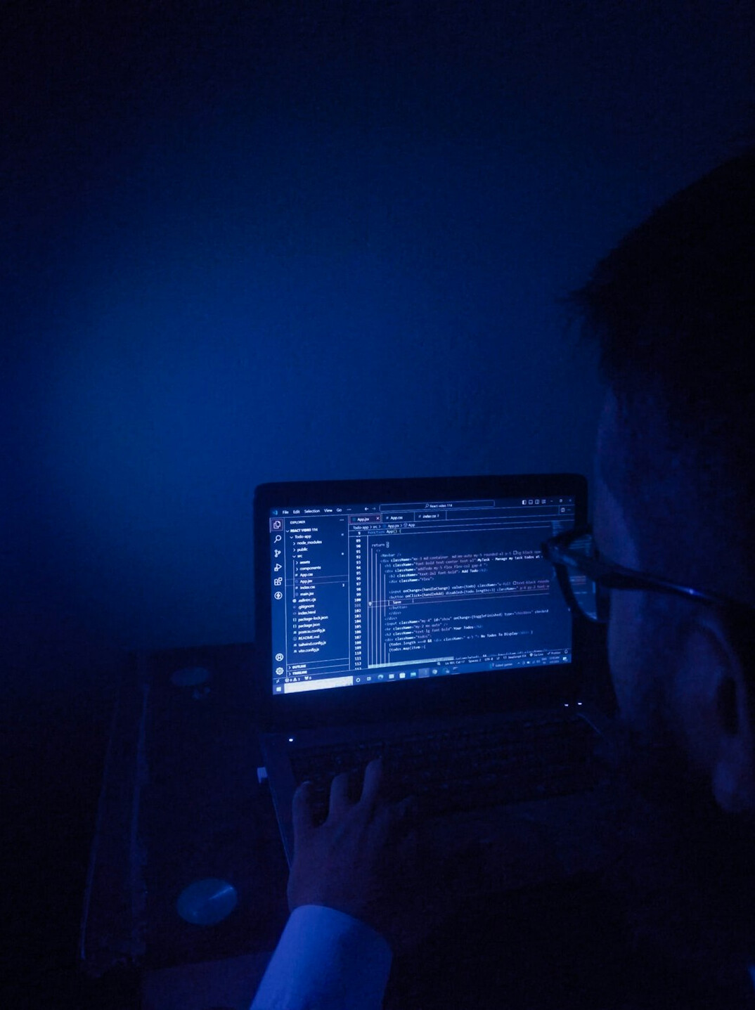 young programmer coding on laptop