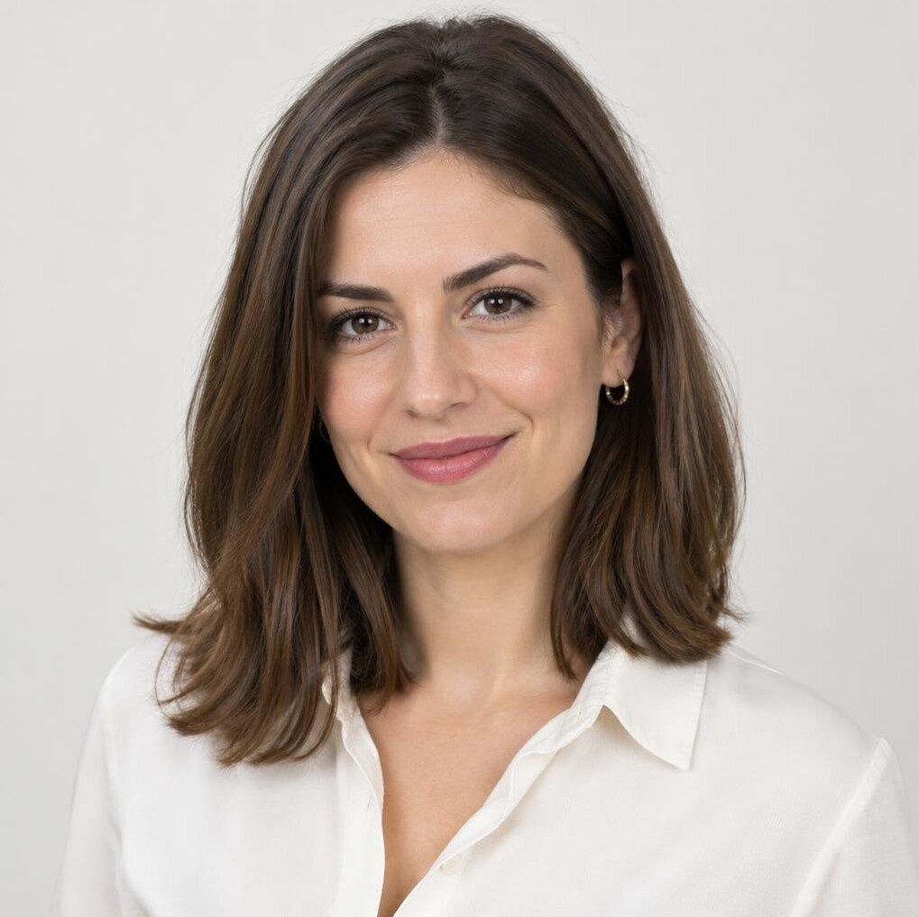 Studio portrait of a Croatian woman with shoulder length brown hair smiling